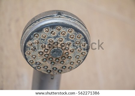 Hard water deposit and rust on shower tap Royalty-Free Stock Photo #562271386