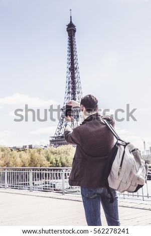 Tourist To Paris Taking Pictures Of The Eiffel Tower