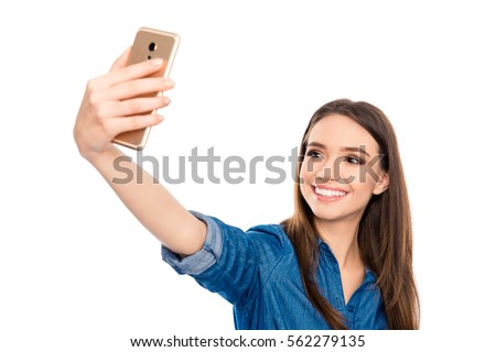 Pretty young happy woman making selfie on smartphone