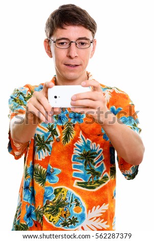 Studio shot of man taking picture with mobile phone