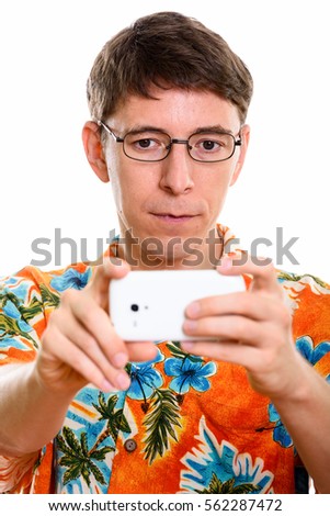 Face of man taking picture with mobile phone