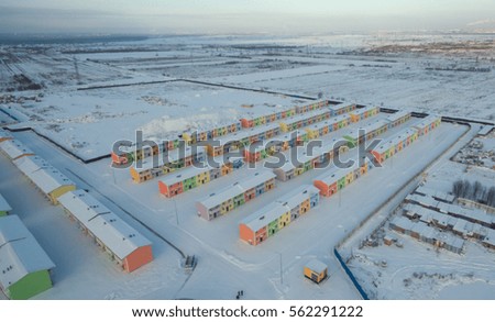 The drone photo of the townhouse village in winter, bright houses under the snow
