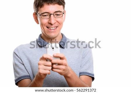 Close up of happy man smiling while using mobile phone