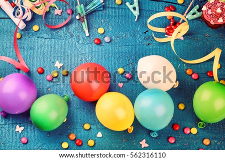 Colorful birthday frame with multicolor party items on dark blue background. Happy birthday concept with copy space