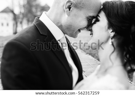 Black and white photo of wedding couple in love standing in park