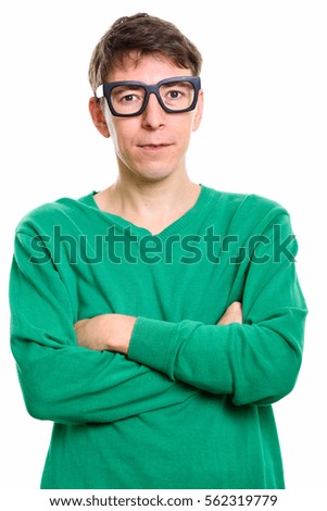 Studio shot of man wearing eyeglasses with arms crossed