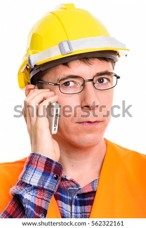 Face of thoughtful man construction worker talking on mobile phone