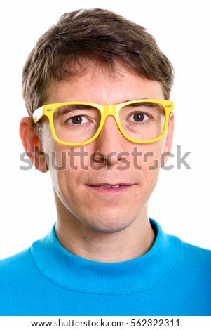 Studio shot of face of man wearing yellow eyeglasses