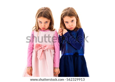 Identical twins girls are sad, lonely and moody. Children are alone,  sad and frustrated, looking at the camera