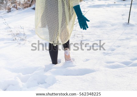 Cute fashion Girl barefoot on white cold snow in winter. Quenching tempering harding health concept. Female feet without shoes. Healthy and Strong organism