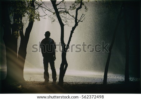 Man standing silhouette Royalty-Free Stock Photo #562372498