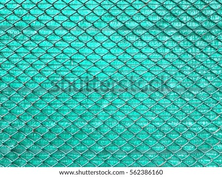 Metal met fence with green background, abstract background.