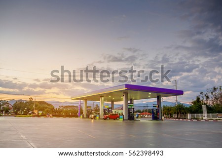 gas station with clouds and sky at sunset Royalty-Free Stock Photo #562398493