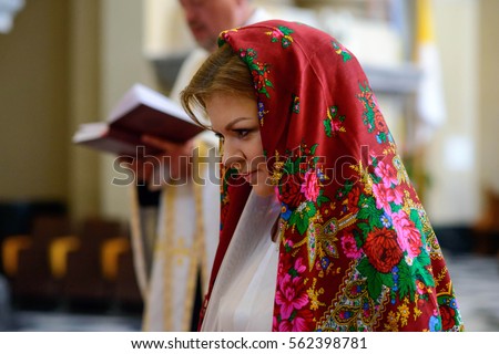 beautiful and young bride in headscarf standing in the church