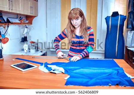 Fashion designer using tablet computer in studio