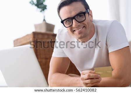 Cheerful pleasant man shopping online