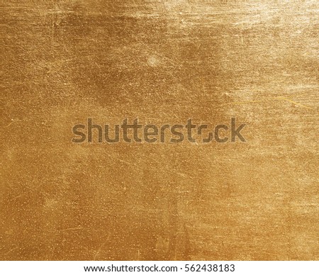 Shiny yellow leaf gold foil texture background Royalty-Free Stock Photo #562438183