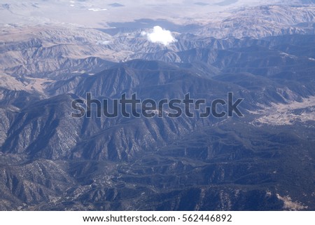 Aerial view landscape from sky birds eye natural landscape rocky mountains lake streams rivers glacier snow cap water fall above beautiful cloud formation atmosphere stratosphere