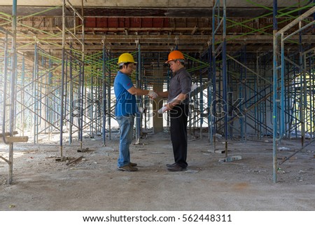 Construction concepts, Engineer and Architect working at Construction Site with blueprint