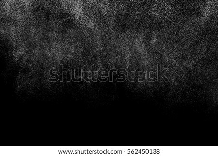 Abstract splashes of water on black background. Freeze motion of white particles. Rain, snow overlay texture.