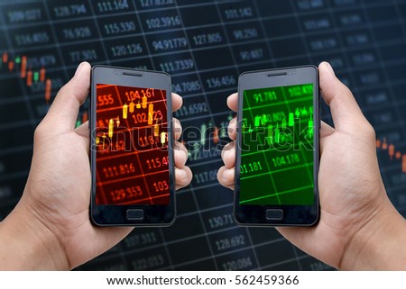 Hands holding smartphones displaying candlestick charts with red and green screens to indicate different stock market situations
