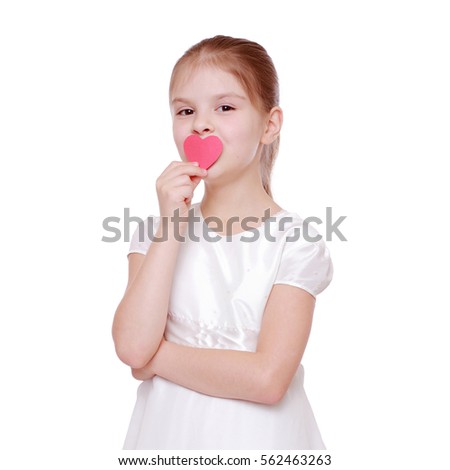 Cute little girl kisses a paper heart
