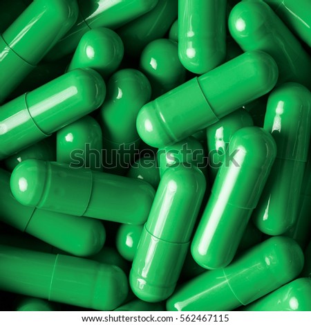medical pills and capsules pattern on blue background. flat lay, top view