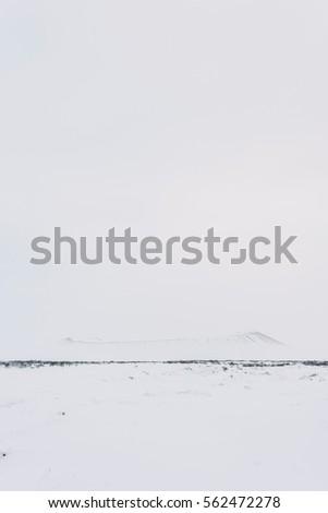 Hverfjall volcano covered in snowy shades of white, myvatn area, Iceland. Vertical photo