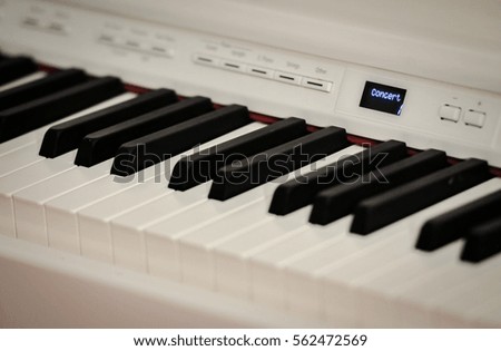 Hand playing on digital piano. Close-up. Small depth of field. 