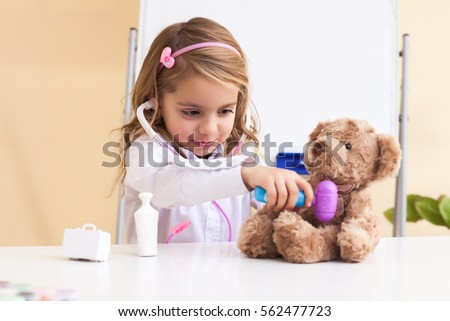 little girl treats a bear, concept and treatment of childhood