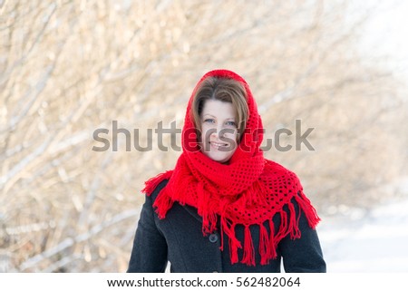 Russian woman with a red knitted shawl outdoors