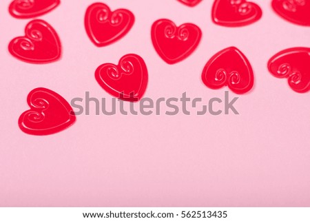 Little red hearts on pink background