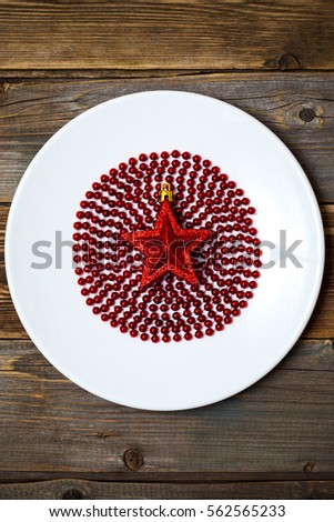 red star on the ruby ball in the white circle on the surface of the old wooden boards background
