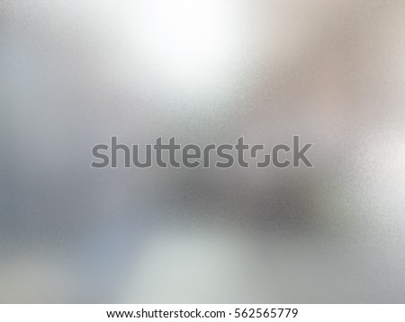 detail of sand glass window with blurred background behind Royalty-Free Stock Photo #562565779