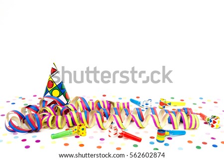 Carnival hats and streamers before white background