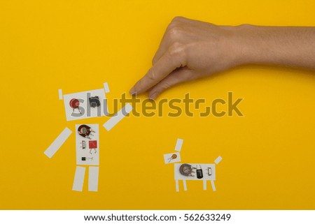 Small paper robot holding a man's hand