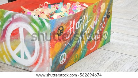 Hand made poster on the box with words "Happy new yaer", Psychedelic hippie love lettering with colorful flowers. Hippy decoration