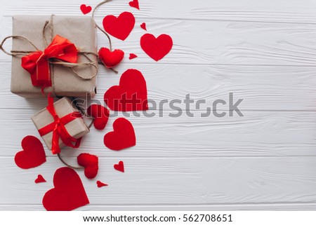 Valentine's Day. gifts, hearts of felt and  decorations on wooden a white background Royalty-Free Stock Photo #562708651