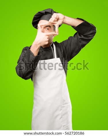 Surprised chef taking a photo