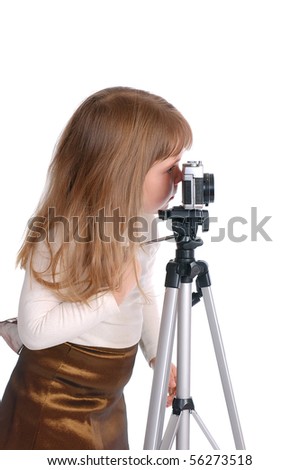 The little girl with the photo camera on the white
