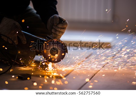 Cutting metal with angle grinder. Royalty-Free Stock Photo #562757560