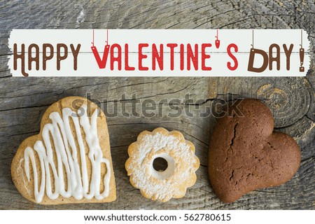 Valentine cookies with heart shape on wooden background, greeting card