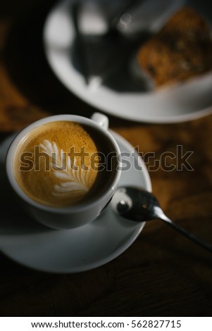 Cappuccino and cake afternoon light play. Picture D