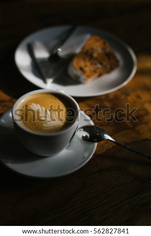 Cappuccino and cake afternoon light play. Picture C