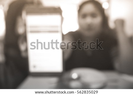 Picture blurred  for background abstract and can be illustration to article of Asian woman showing smartphone