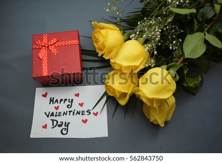 Yellow roses , a gift and Happy Valentine's Day text on a white note