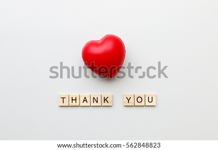 THANK YOU text word made with wood blocks and Red Heart on table