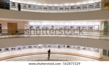 abstract image of people  watching photograph or image in the lobby of a modern art gallery museum,a blurred background