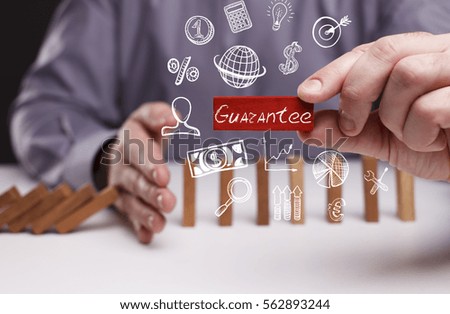 Business, Technology, Internet and network concept. Young businessman shows the word: Guarantee 
