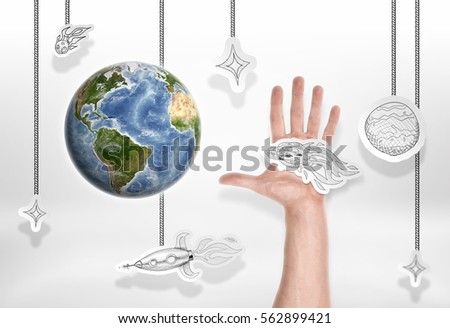 The Earth on a background of small pictures of stars and other cosmic objects and male hand. Damaging the planet. Asteroid close approaching. Reproduction of the space. Elements of this image are